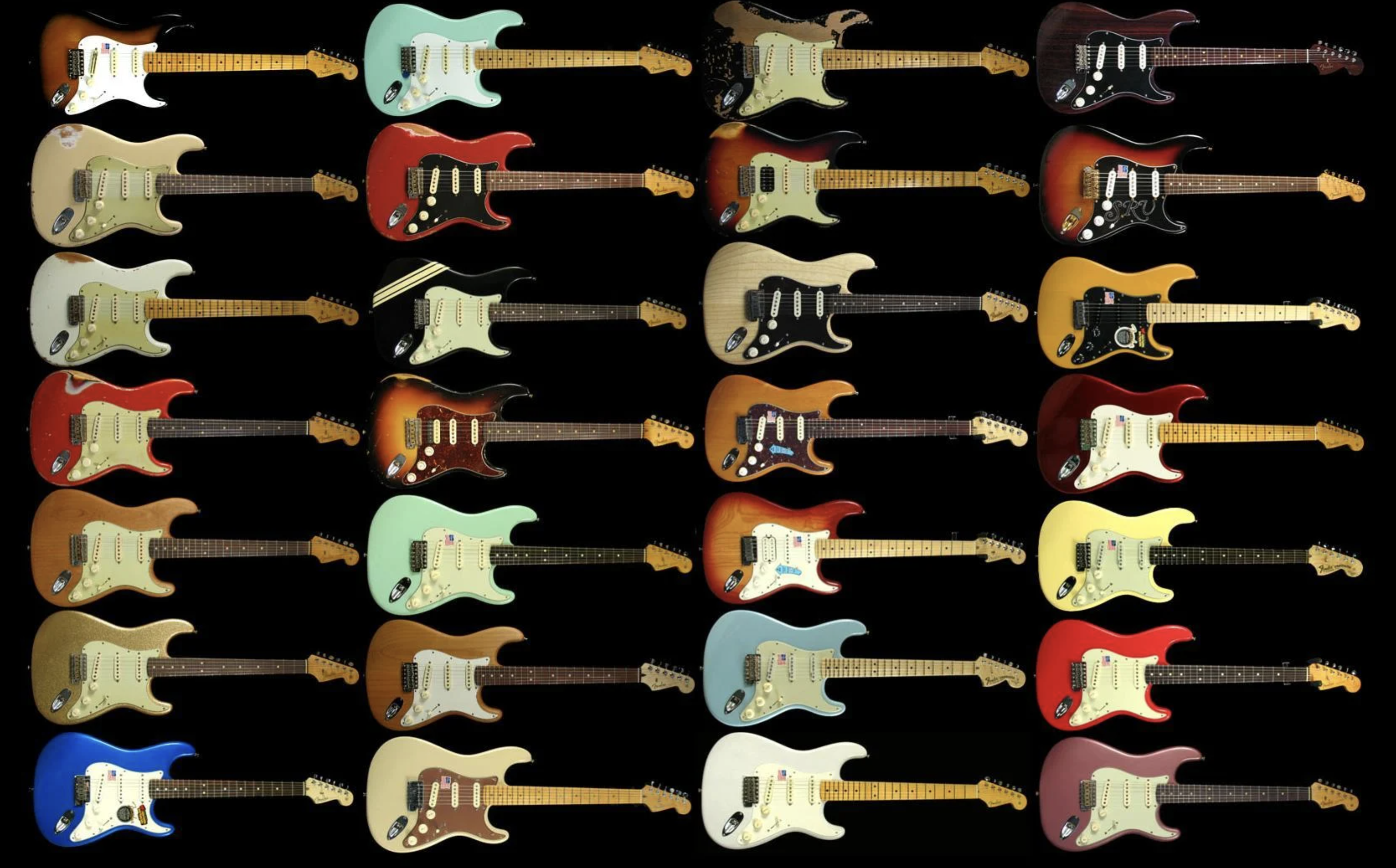 Grid of electric guitars in many different finishes on a black background